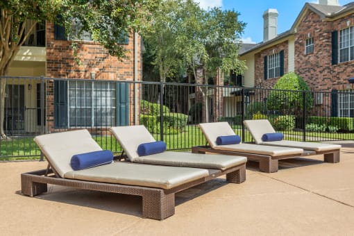 pool deck with chaise lounge chairs at Aston at Cinco Ranch, Katy, Texas