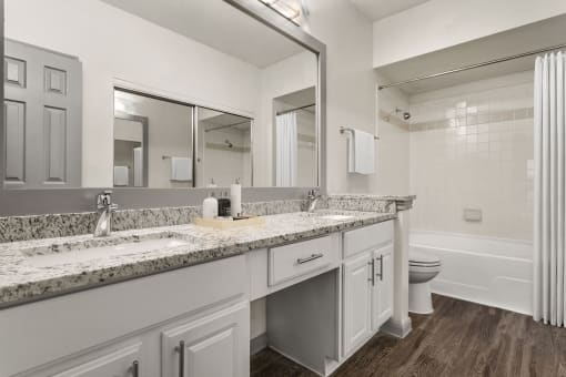 a bathroom with a sink and a toilet and a mirror at Aston at Cinco Ranch, Katy, 77450
