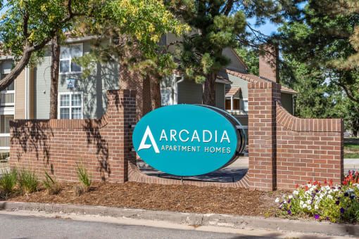 our sign in front of a brick building at Arcadia Apartments, Colorado, 80112