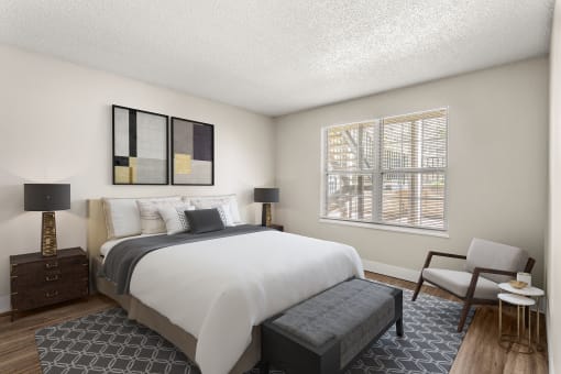 a bedroom with a large bed and a window  at Arcadia Apartments, Centennial, CO