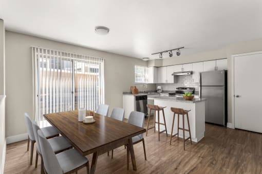 a kitchen and dining room with a table and chairs at Arcadia Apartments, Centennial, Colorado