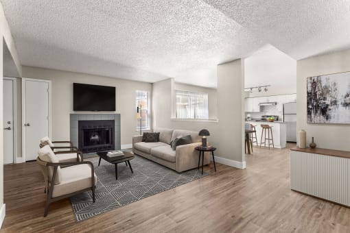 a living room with a couch and chairs and a fireplace at Arcadia Apartments, Colorado, 80112