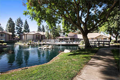 Pond area with water feature and places to roam around in the sun at Citrine Hills, Ontario, 91761
