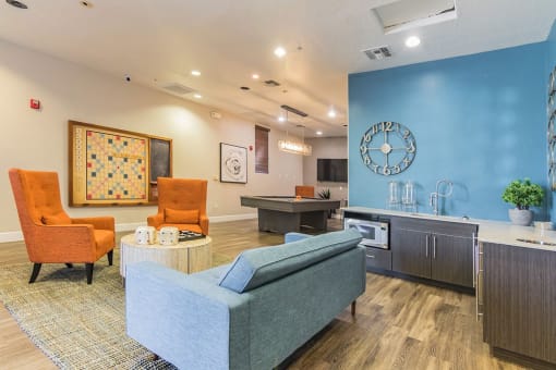 a living room with a blue wall and a kitchen at Element Deer Valley, Phoenix