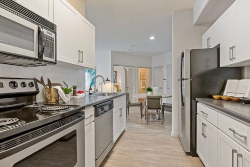 a kitchen with stainless steel appliances and white cabinets at Element Deer Valley, Phoenix, AZ