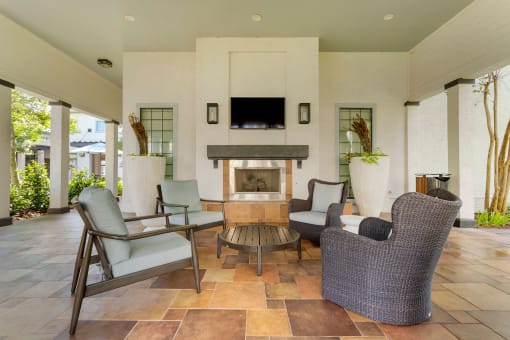 a living room with furniture and a fireplace at Summerwind, Pearland, 77584