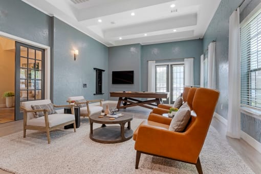 a living room with blue walls and an orange couch at Summerwind, Texas, 77584