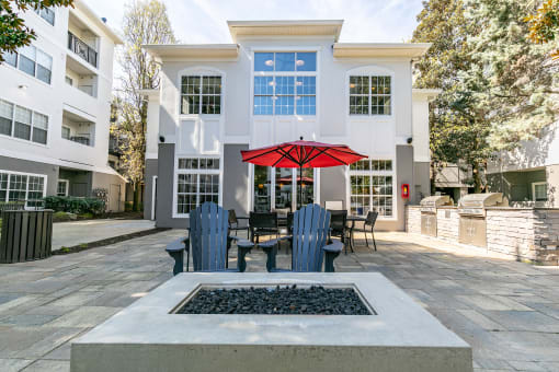 a courtyard with a fire pit and patio furniture in front of a building at Willowest in Lindbergh, Atlanta