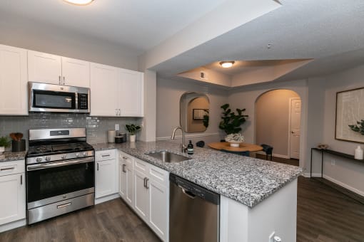 a kitchen with granite counter tops and stainless steel appliances at Willowest in Lindbergh, Atlanta, GA, 30318