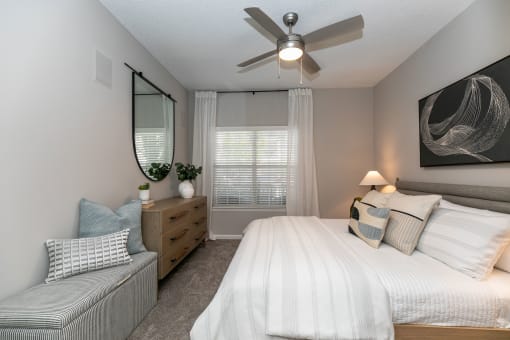 create a relaxing bedroom with a large bed and a ceiling fan at Willowest in Lindbergh, Atlanta