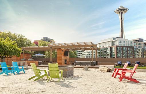 Beach chairs are arranged on a sandy beach at Skye at Belltown Apartments, Seattle, Washington