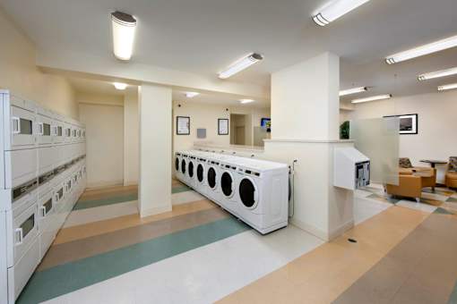 A laundry room with washers and dryers at Skye at Belltown Apartments, Seattle