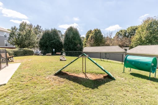 a park with a swing set and a chain link fence at Roswell Village, Georgia, 30075