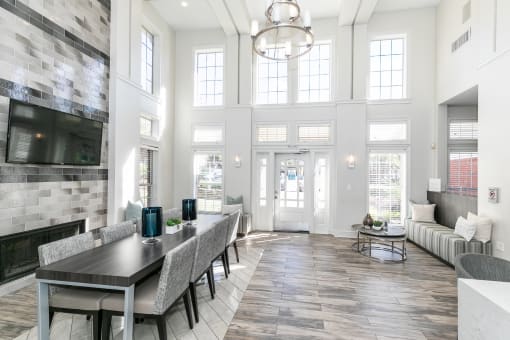 a large living room with a dining room table and a fireplace at Roswell Village, Roswell, Georgia