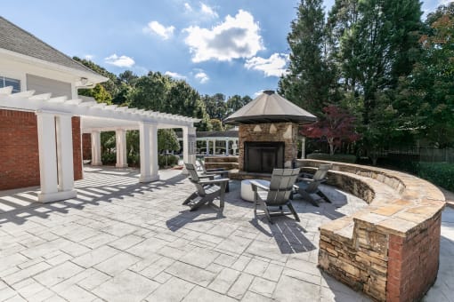 a patio with a stone fireplace and patio furniture at Roswell Village, Roswell, 30075