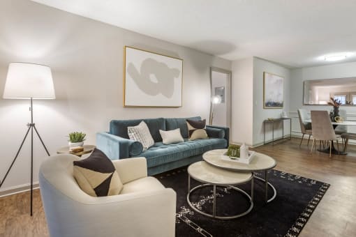 a living room with a blue couch and a table at Roswell Village, Georgia, 30075