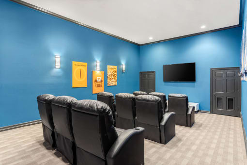 our theater room with a blue wall and chairs at Villages of Cypress Creek, Houston