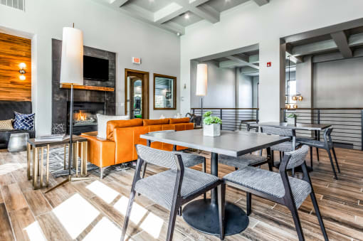 a living room with tables and chairs and a fireplace at The links at Plum Creek Apartments, Castlerock, 80104