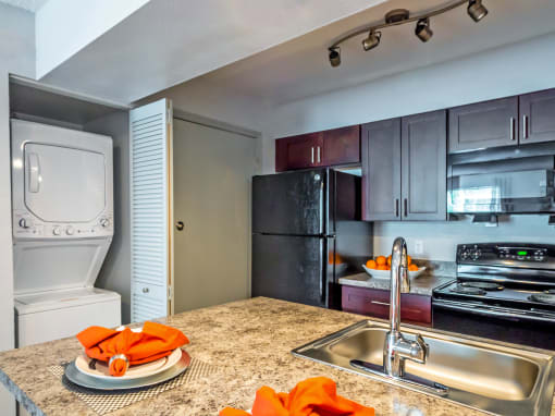 full kitchen with stainless steel appliances and granite counter tops and a sink at Skyview Apartments, Westminster, CO 80234