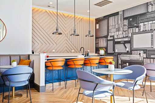 a restaurant with blue chairs and a counter with orange chairs at The Olivine, Austin, Texas