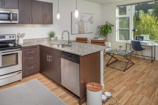 an open floor plan with a kitchen and living room at The Parker Apartments, Portland