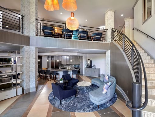 a living room and dining room with a spiral staircase at The Tribute, Raleigh, NC, 27612