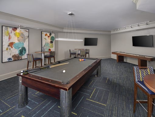 a games room with a pool table and two televisions at The Tribute, Raleigh, North Carolina