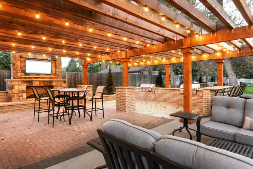 a patio with a table and chairs under a pavilion with lights at Verdant, Boulder, CO, 80303