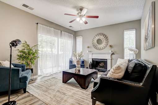 Living room with fireplace and ceiling fan1 at Wyndchase Aspen Grove Apartments, Franklin, 37067