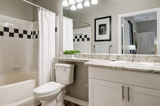 Bathroom with granite countertop and white cabinetry at Wyndchase Aspen Grove Apartments, Tennessee, 37067