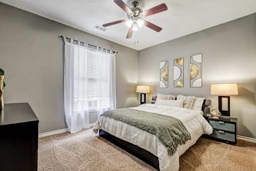 Bedroom with ceiling fan and artwork above bed at Wyndchase Aspen Grove Apartments, Tennessee, 37067