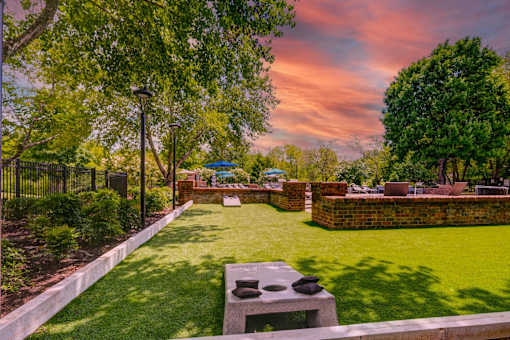 Putting green with cornhole game and landscaping at Wyndchase Aspen Grove Apartments, Franklin, 37067