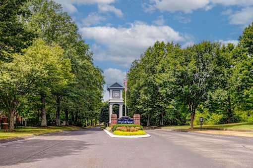 Clock tower entrance monument surrounded by trees at Wyndchase Aspen Grove Apartments, Tennessee