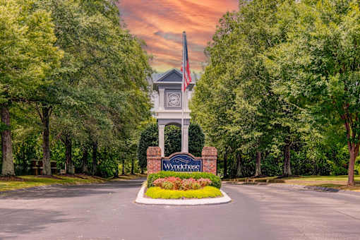 Property entrance monument with flagpole and landscaping at Wyndchase Aspen Grove Apartments, Tennessee, 37067