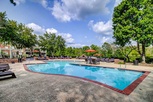 Pool area with patio furniture and orange umbrellas at Wyndchase Aspen Grove Apartments, Franklin, 37067