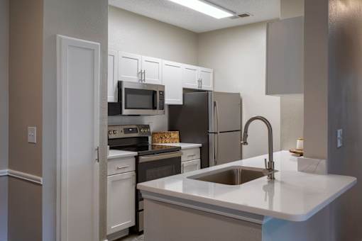 Modern kitchen with white cabinetry and island at Wyndchase Aspen Grove Apartments, Franklin, TN