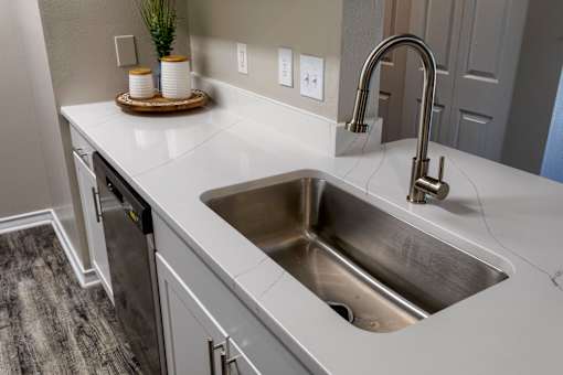 Undermount sink with pulldown faucet and white countertop at Wyndchase Aspen Grove Apartments, Franklin, TN 37067