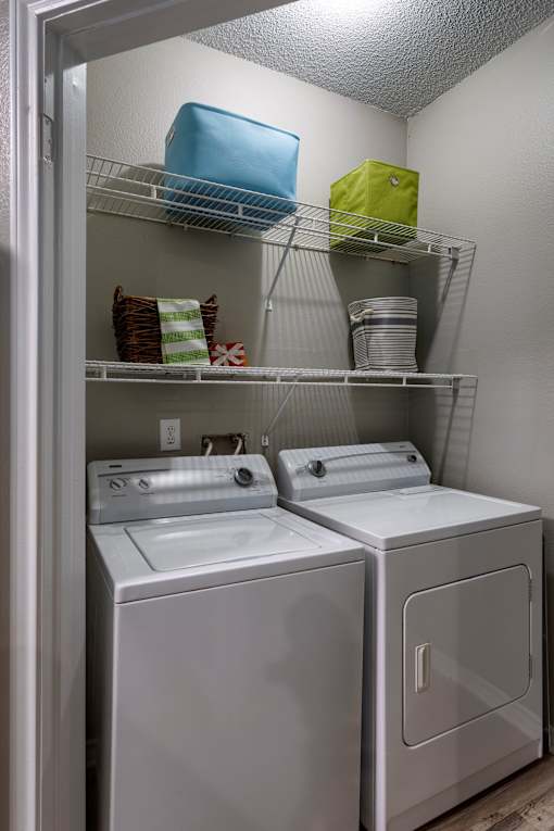In unit washer and dryer with overhead shelving at Wyndchase Aspen Grove Apartments, Franklin, TN 37067
