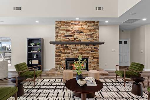 A living room with a fireplace and a black and white tiled floor.