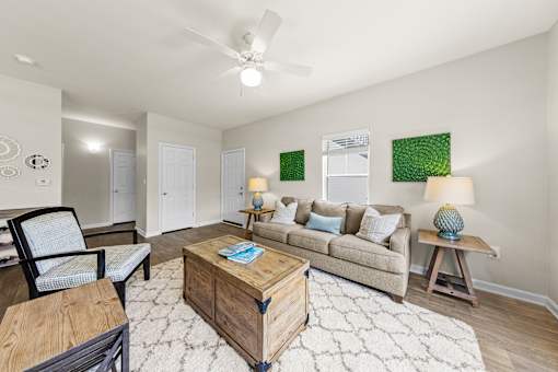 A living room with a couch, chair, and coffee table.
