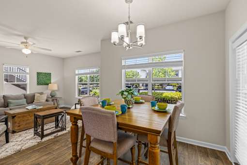 A dining room with a wooden table set for four.