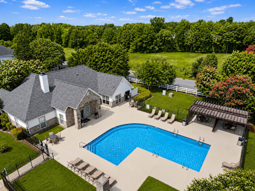 A large house with a pool in the backyard.
