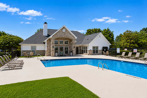 A large house with a pool in the backyard.