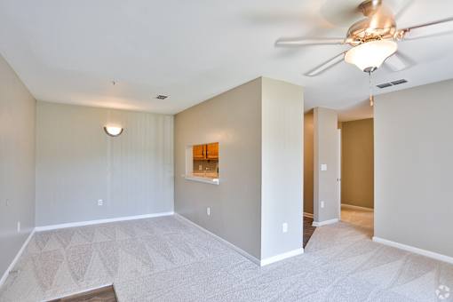 A room with a ceiling fan and a light fixture.