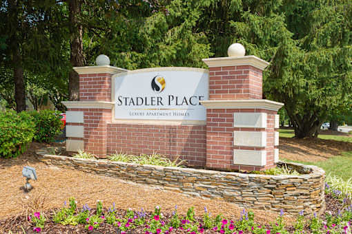 A sign for Stadler Place reads "Luxury Apartment Homes.".