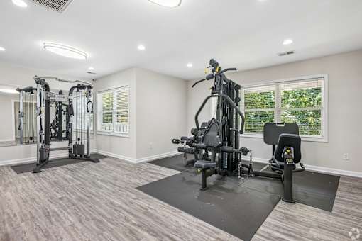 A spacious home gym with a variety of equipment.