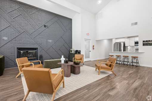 A living room with a fireplace and a grey wall.