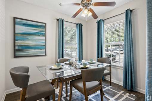 A dining room with a glass table and chairs.