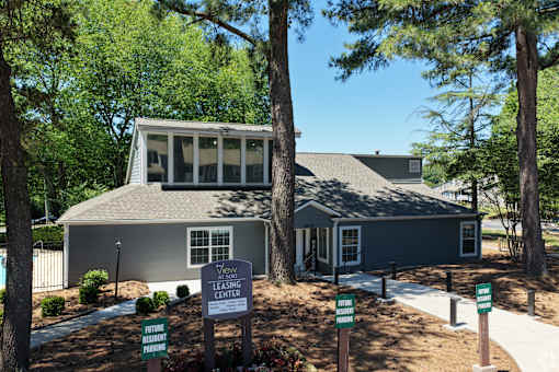 A leasing center is located in a wooded area.