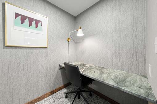 A room with a desk and a chair.